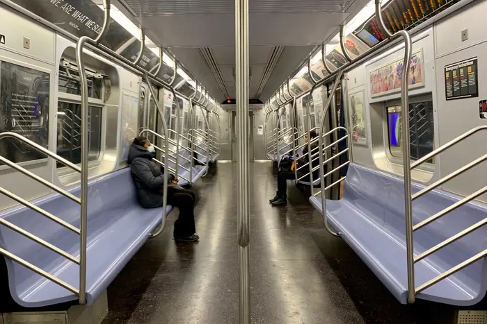 A nearly-empty NYC subway train during the COVID-19 crisis,  the result of stay-at-home orders from the state.